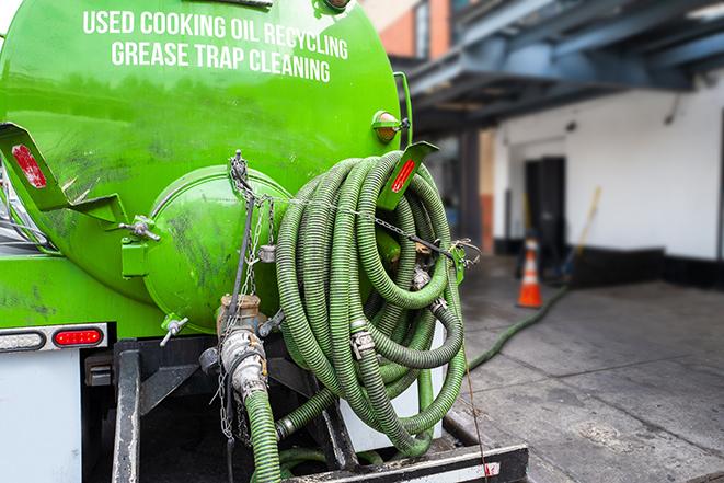 a grease trap pumping truck at a restaurant in Manassas